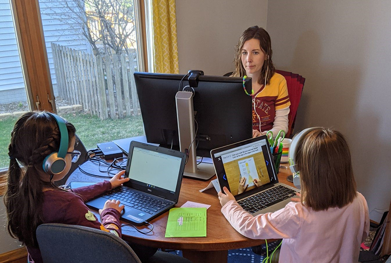 Liz Harris and her daughters work at the kitchen table 