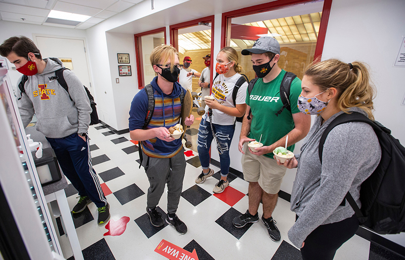 Masked freshmen purchase ice cream cups at the Creamery