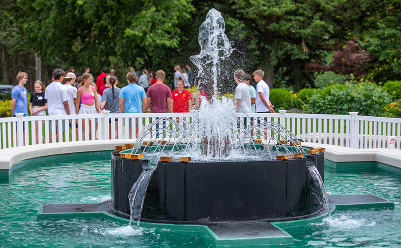 Student tour group doesn't notice bubbling fountain behind it