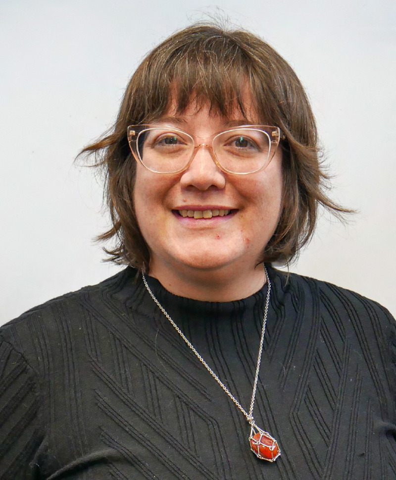 Head shot of white woman in glasses and black blouse