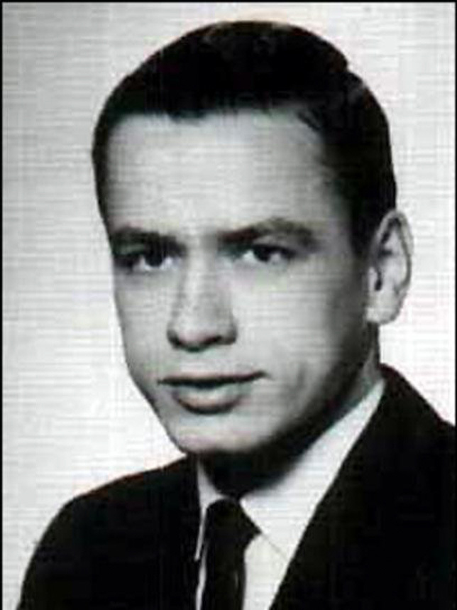 Black and white college yearbook photo of white man in jacket an