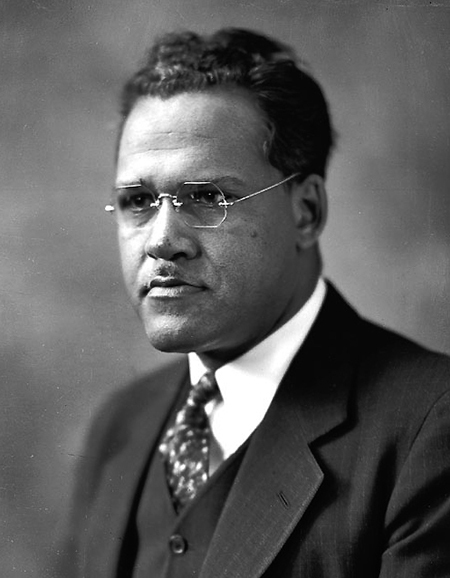 black and white archival photo of Black man in suit with wire gl